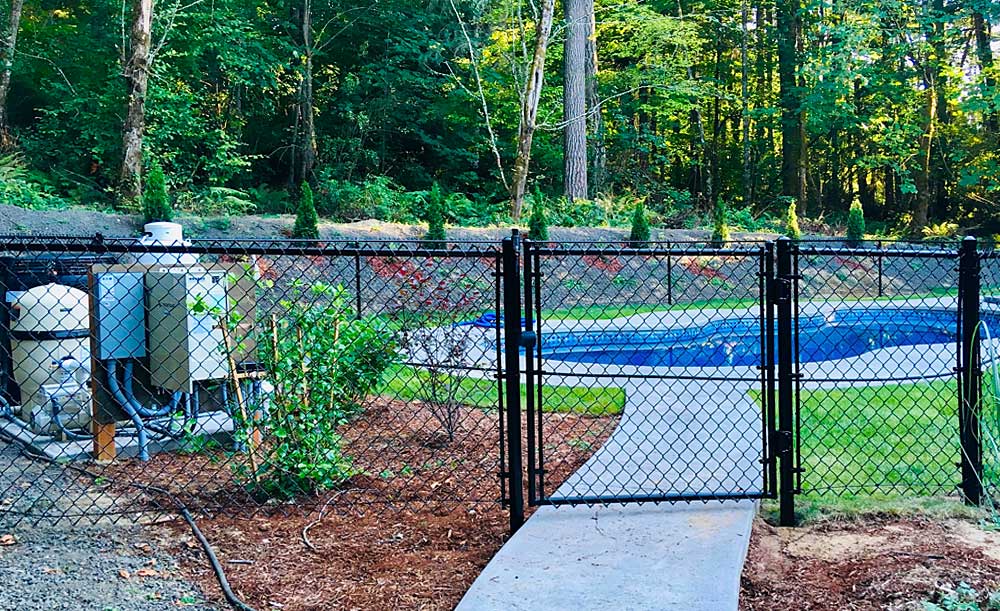 Black chain link fence with single-swing gate